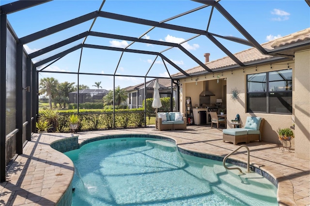 view of pool with a lanai, an outdoor hangout area, a patio, and an outdoor kitchen