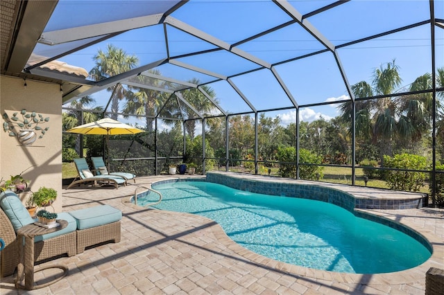 view of pool featuring a patio area and glass enclosure