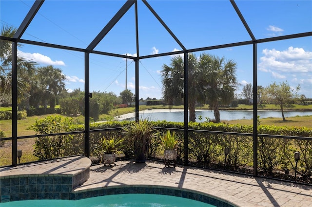 view of swimming pool with a lanai, a patio, and a water view