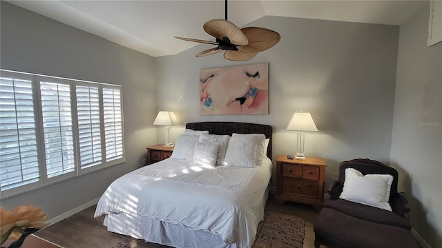 bedroom featuring ceiling fan, dark hardwood / wood-style floors, and vaulted ceiling