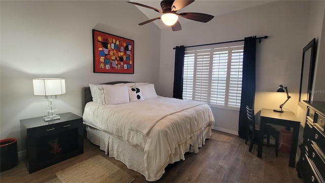 bedroom with dark hardwood / wood-style floors and ceiling fan