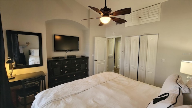 bedroom with high vaulted ceiling, a closet, and ceiling fan