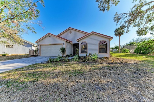 single story home with a garage and a front lawn