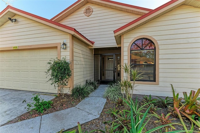 view of exterior entry with a garage