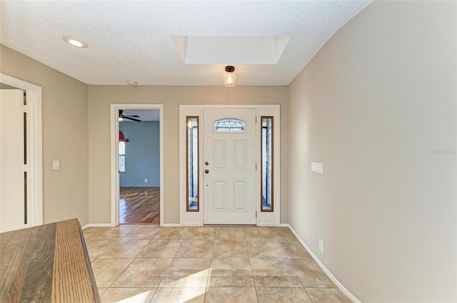 tiled entryway featuring a textured ceiling