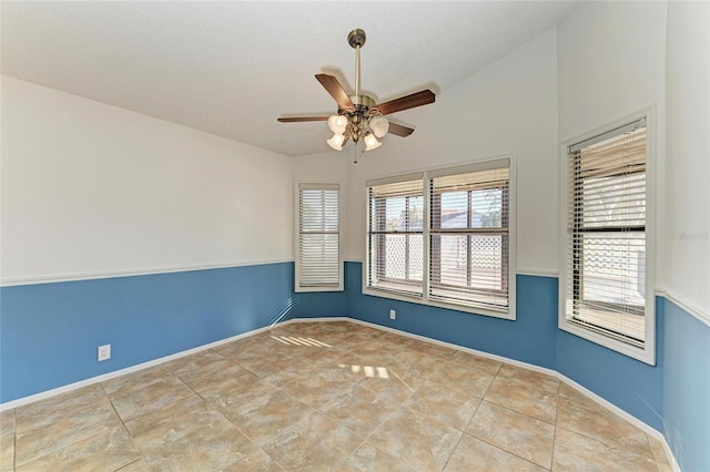 unfurnished room featuring vaulted ceiling, light tile patterned floors, and ceiling fan