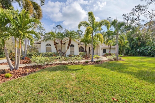 mediterranean / spanish house with a front lawn