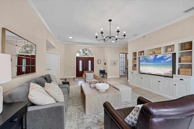 living room with a notable chandelier, crown molding, built in features, and light wood-type flooring