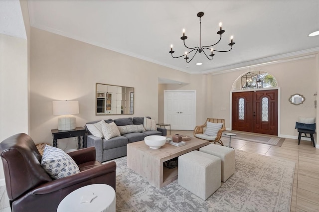 tiled living room featuring an inviting chandelier and ornamental molding