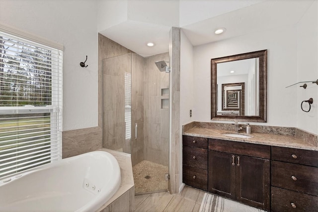 bathroom with independent shower and bath and vanity