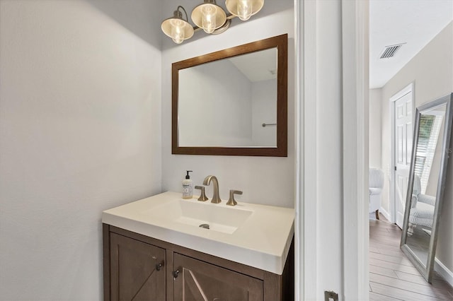 bathroom with vanity and hardwood / wood-style floors