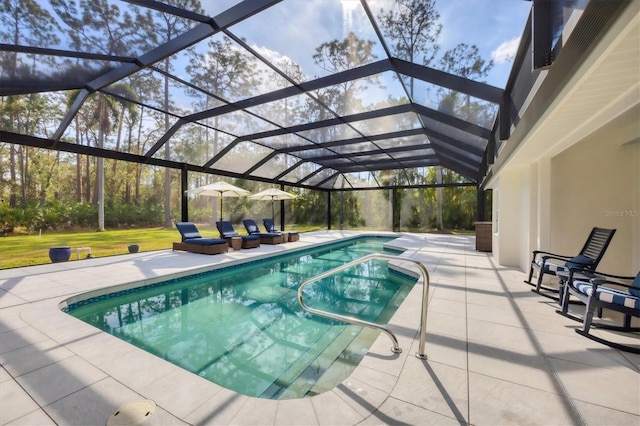 view of swimming pool featuring a lanai and a patio