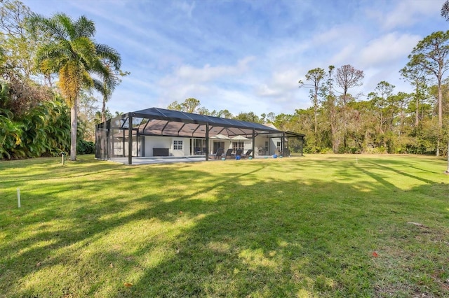 view of yard featuring a patio area and glass enclosure