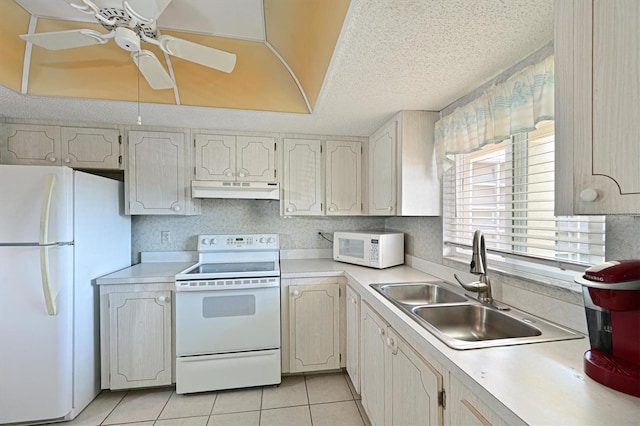 kitchen with sink, light tile patterned floors, white appliances, ceiling fan, and a textured ceiling