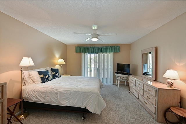 bedroom with ceiling fan, a textured ceiling, and carpet flooring