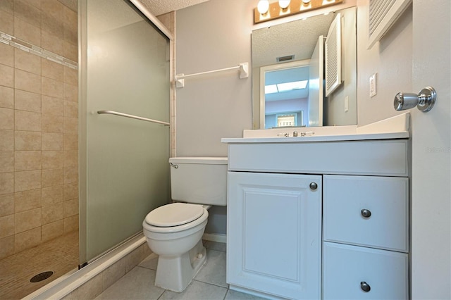 bathroom with tile patterned flooring, vanity, a shower with shower door, and toilet