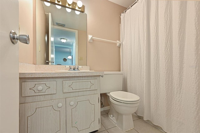 bathroom with tile patterned flooring, vanity, and toilet