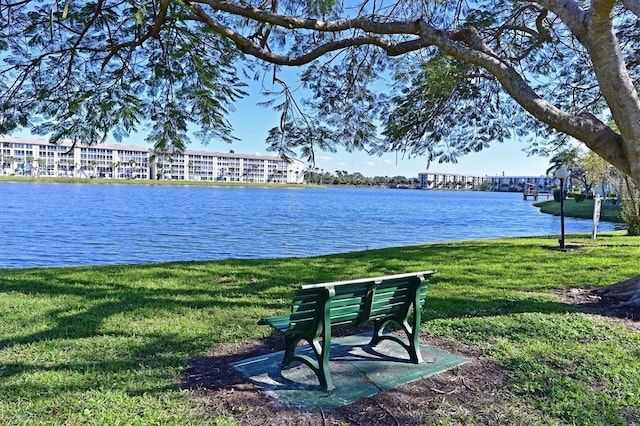 view of property's community with a yard and a water view