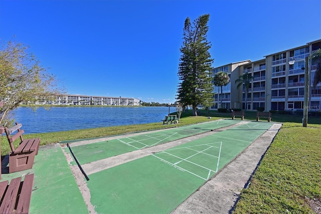 view of home's community featuring a water view and a lawn