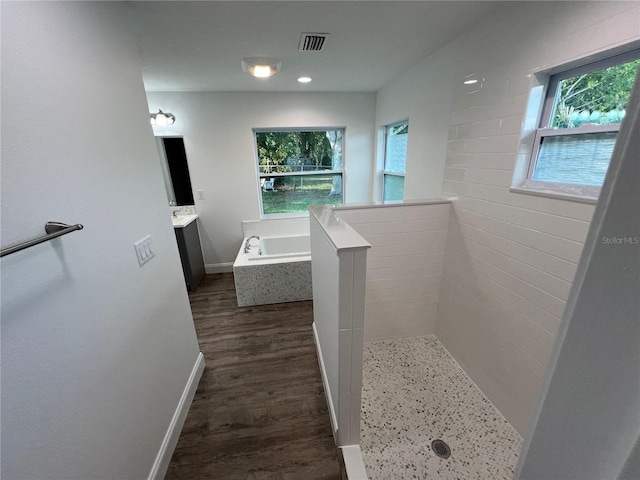 bathroom featuring vanity, hardwood / wood-style floors, and separate shower and tub