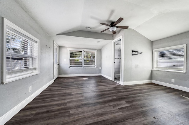 spare room featuring dark wood-type flooring, ceiling fan, and lofted ceiling