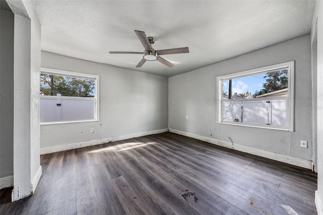 empty room featuring ceiling fan, dark hardwood / wood-style floors, and a textured ceiling