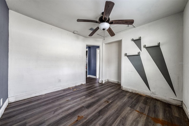 unfurnished room with ceiling fan and dark hardwood / wood-style flooring