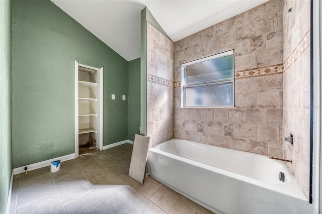 bathroom featuring a tub to relax in and tile patterned flooring