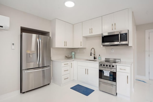 kitchen with white cabinetry, sink, a wall mounted air conditioner, and appliances with stainless steel finishes