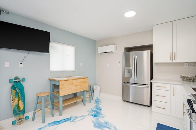 kitchen with white cabinetry, stainless steel appliances, and a wall mounted air conditioner