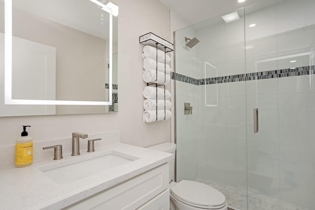 bathroom with vanity, an enclosed shower, and toilet