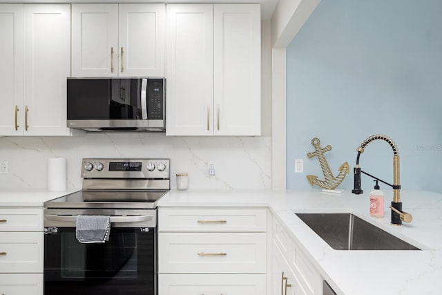 kitchen featuring white cabinetry, appliances with stainless steel finishes, and sink