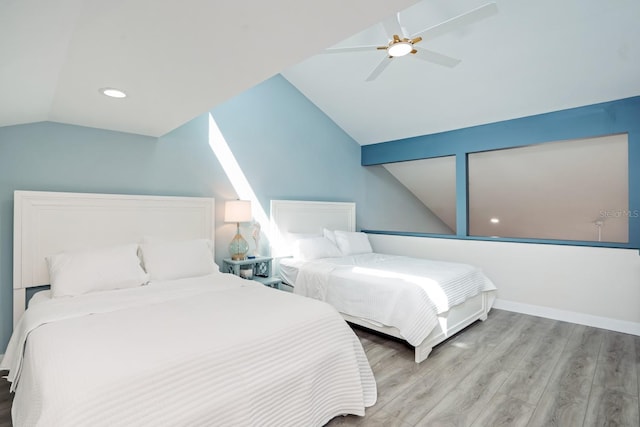 bedroom featuring ceiling fan, lofted ceiling, and light hardwood / wood-style floors