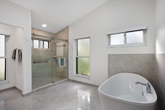 bathroom with lofted ceiling and separate shower and tub