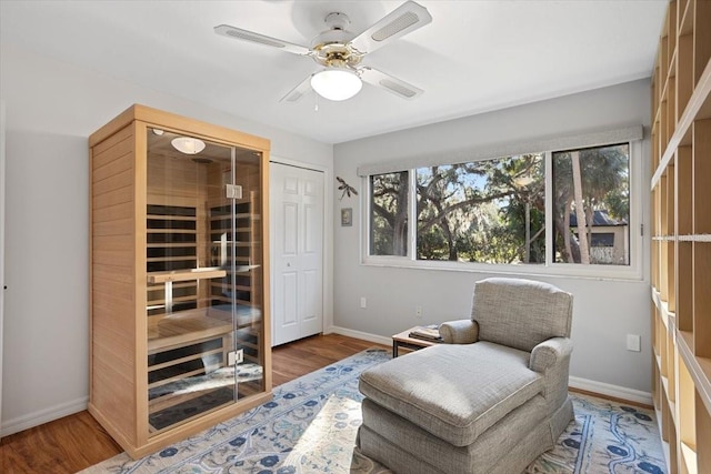 sitting room featuring hardwood / wood-style flooring and ceiling fan