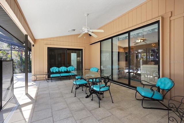 sunroom with ceiling fan and vaulted ceiling