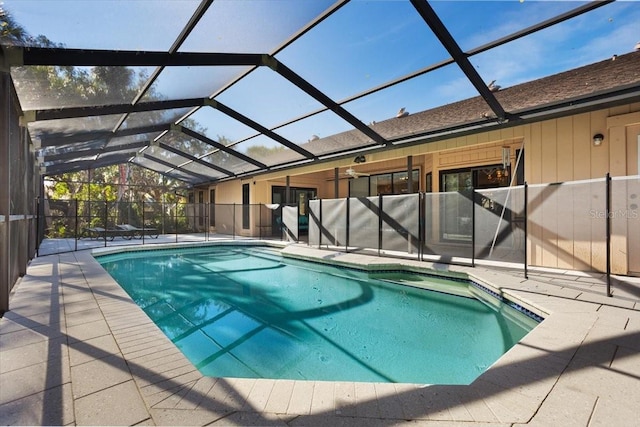 view of swimming pool featuring a patio and a lanai