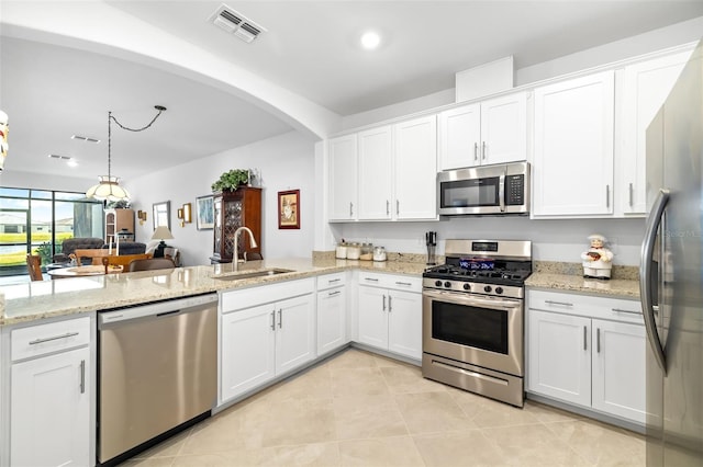 kitchen featuring white cabinetry, appliances with stainless steel finishes, sink, and light tile patterned floors