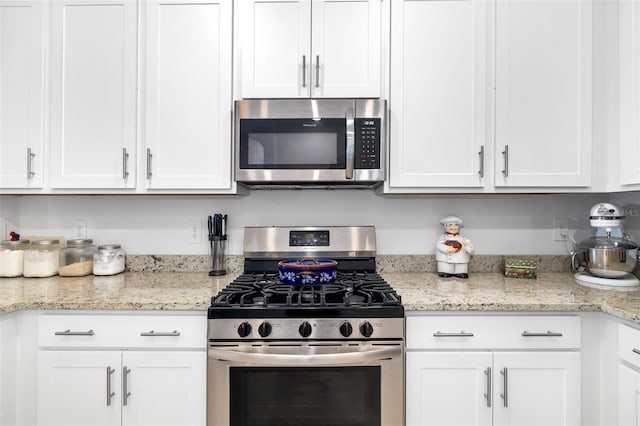 kitchen featuring white cabinetry, light stone countertops, and stainless steel appliances