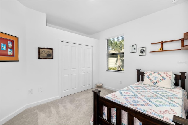 bedroom with light colored carpet and a closet