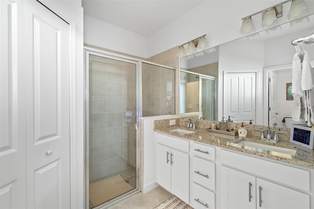 bathroom with tile patterned flooring, vanity, and an enclosed shower