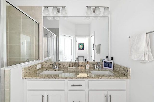 bathroom featuring a shower with door, vanity, and toilet