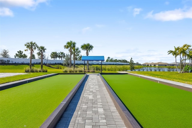 view of property's community featuring a water view and a yard