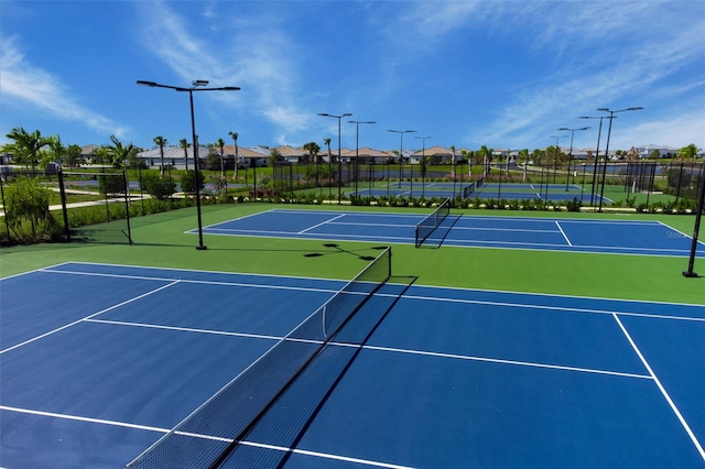 view of tennis court featuring basketball court