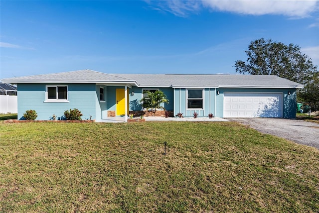 ranch-style house featuring a garage and a front lawn