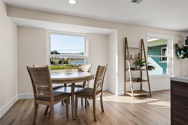 dining space with light hardwood / wood-style floors