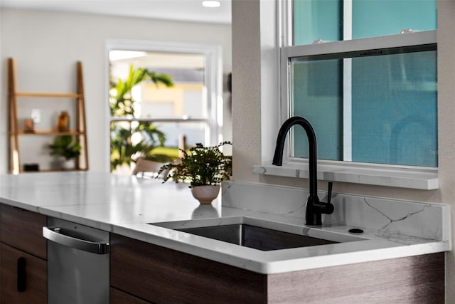 interior details with dark brown cabinets and sink