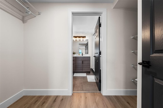 walk in closet featuring light hardwood / wood-style flooring