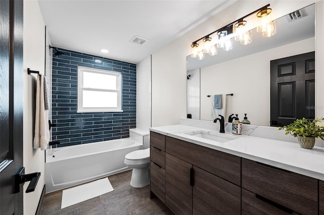 full bathroom featuring tiled shower / bath combo, vanity, and toilet