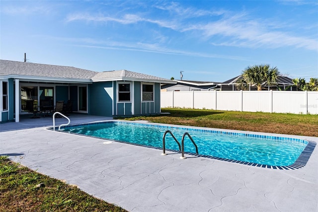 view of pool with a yard and a patio area